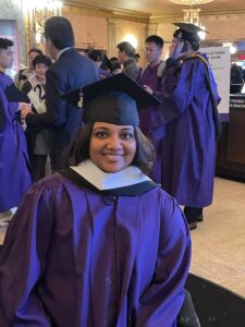 A young woman in a graduation cap and gown