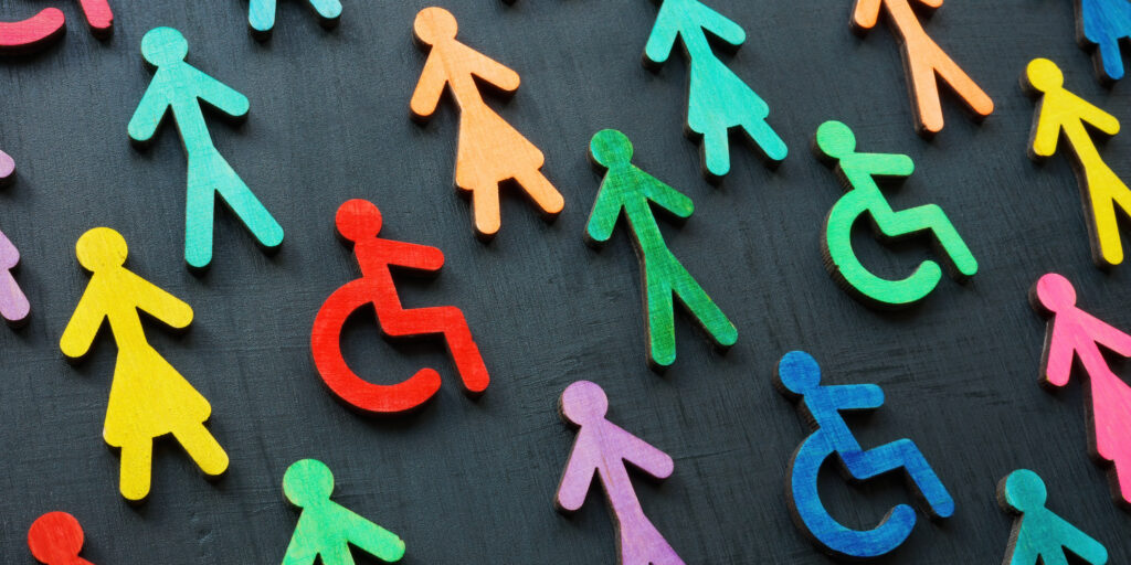 Colorful figurines on the dark surface. Diversity and inclusion concept.