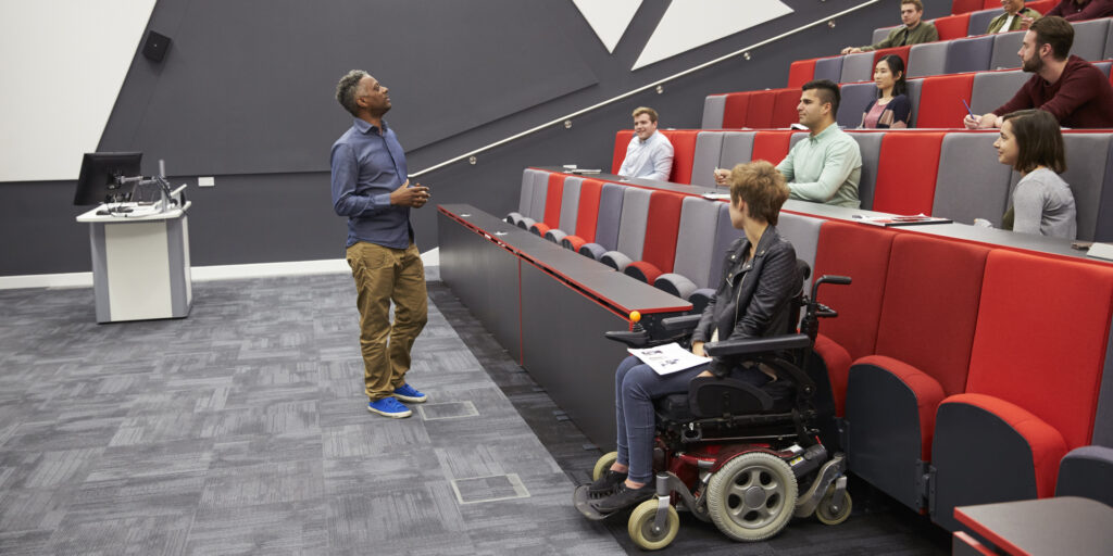 Man lecturing students in a university lecture theatre
