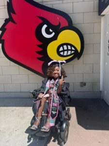 Gabrielle joyously celebrating at her graduation from the University of Louisville in May of 2024.