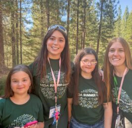 Two young campers pose with two volunteer counselors at MDA Summer Camp