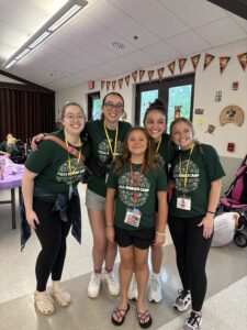 Charlotte at MDA camp with her cabin counselors