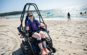 Gwen driving an Action Trackchair at Her ALS Story Retreat 2025