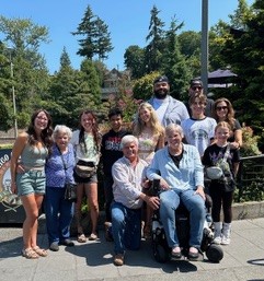 A large family with multigenerational members poses for a photo