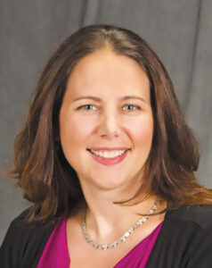 Headshot of Dr. Lorelai Thornburg wearing professional attire against a gray background.