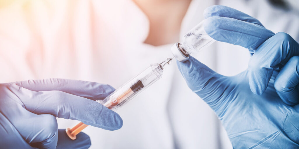 injecting injection vaccine vaccination medicine flu man doctor insulin health drug influenza concept - stock image