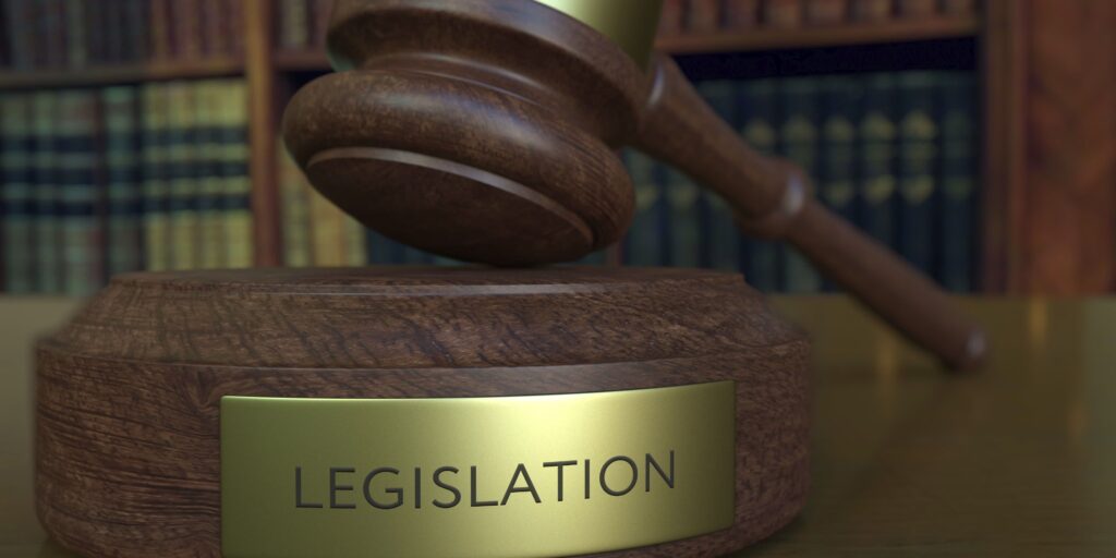 Judge's gavel falling and hitting the block with LEGISLATION inscription. 3D