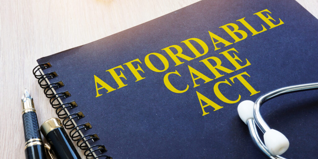 Affordable Care Act ACA and stethoscope on a table.