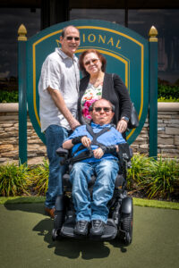 John with his parents at an Ed Morse MDA Golf Classic.