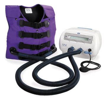 Purple airway clearance vest connected by hoses to a portable therapy device.