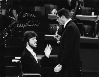 A black and white photo of MDA Telethon with Donnie and Jerry Lewis on stage