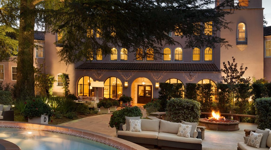 Hotel courtyard with a fountain at dusk.