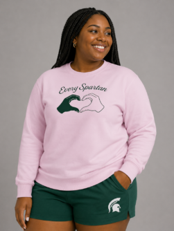 A woman poses in a long sleeve t-shirt that says Every Spartan